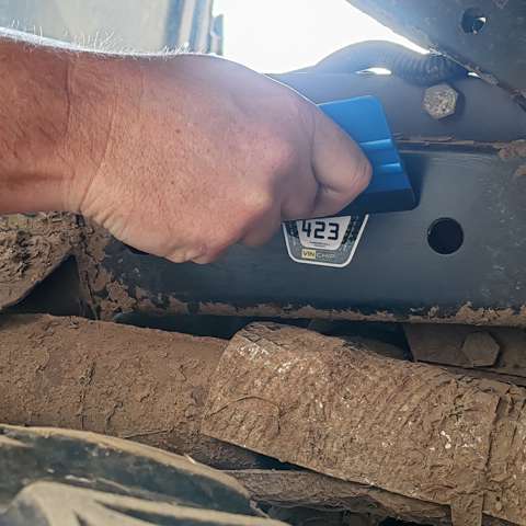 A VIN CHIP tamper-evident warning label being applied to a vehicle as part of security measures.