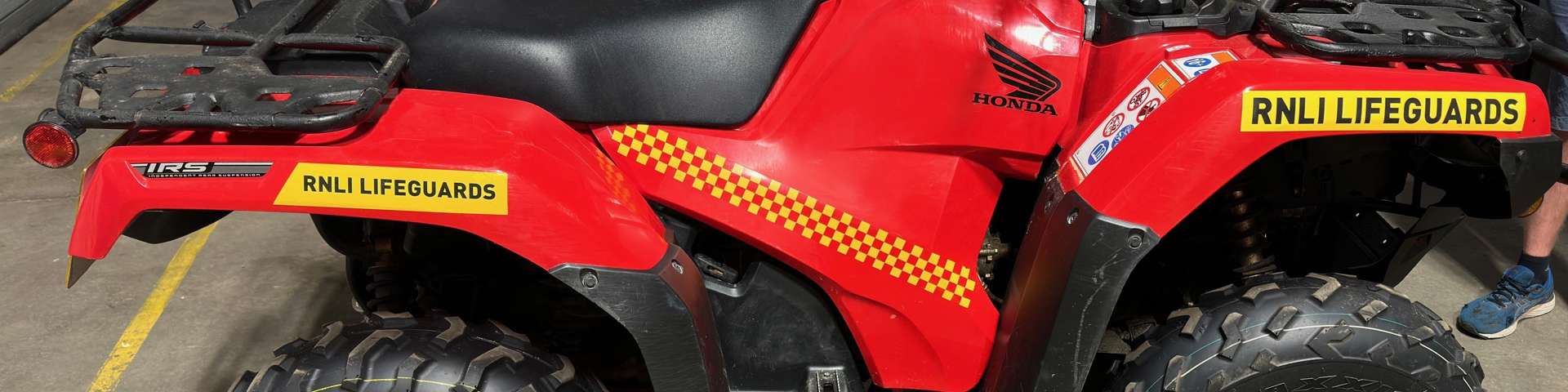 RNLI red Honda quadbike used for beach patrol and lifesaving operations on Merseyside