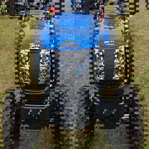Blue Solis tractor with VIN Chip security marking on the front bonnet, displayed on a showground.