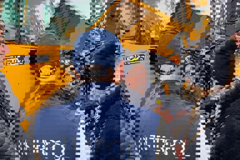 Trainer Nick Mayell providing practical training near yellow heavy plant machinery.