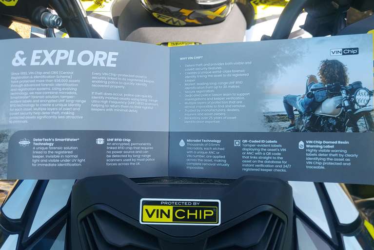 VIN Chip motorcycle security brochure displayed on a VIN Chip branded quad bike showcasing motorcycle theft prevention technology.
