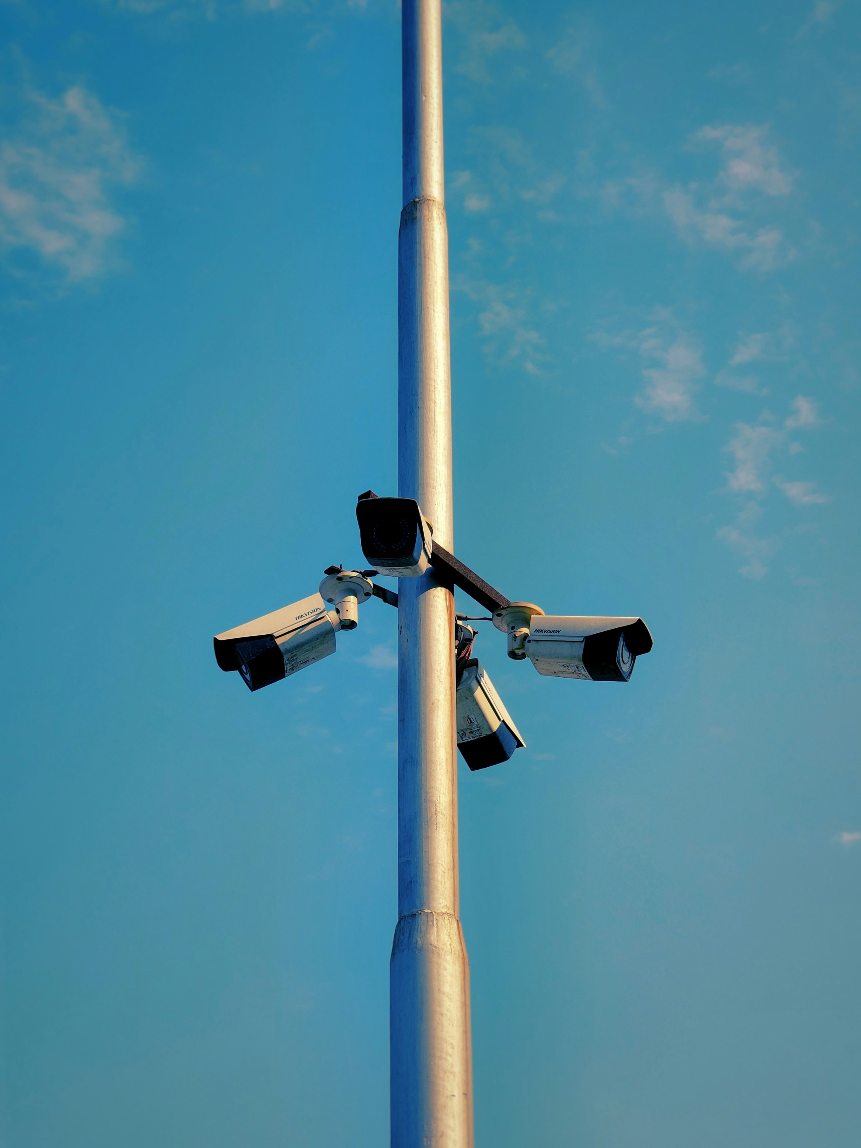A street light equipped with four cameras attached to its pole.