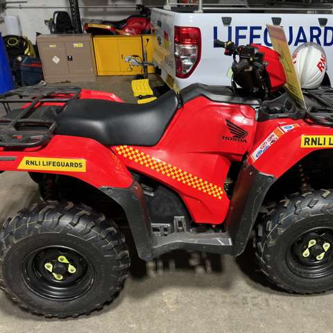 RNLI red Honda quadbike used for beach patrol and lifesaving operations on Merseyside