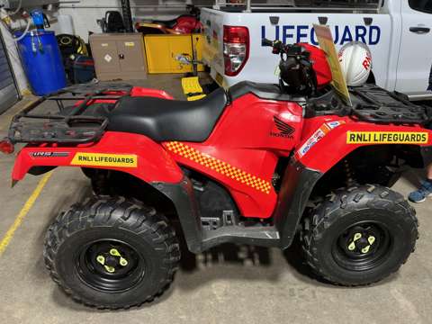 RNLI red Honda quadbike used for beach patrol and lifesaving operations on Merseyside