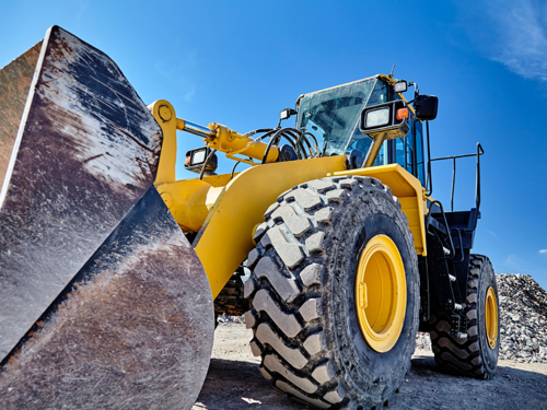 Stationary yellow loader on a construction site.