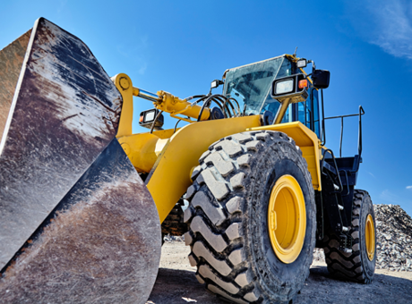 Stationary yellow loader on a construction site.