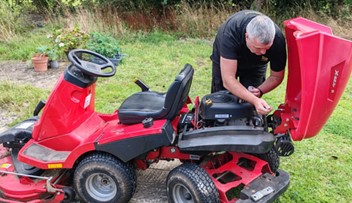 Installing a VIN CHIP security system on a red Solo/Alko ride-on lawn mower.
